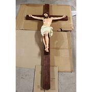 Crucifix statue featuring Jesus with a crown of thorns in a classical, old world European style with ornate, Renaissance details. Side Angle View