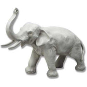 Elephant figurine with raised trunk, detailed classical sculpting, old world European style, ornate and lifelike features.