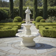Saint statue fountain with ornate scalloped basin, classical pedestal, and old world European Renaissance-inspired detailing. Side Angle