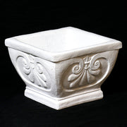 Square planter with ornate Baroque scrollwork and classical old world European detailing on a pedestal base. Side Angle