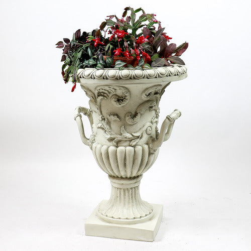 Ornate urn planter with classical Baroque detailing, acanthus leaf motifs, and scroll handles on a pedestal base. Side Angle