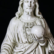 Jesus statue in classical Renaissance style, featuring ornate drapery and detailed facial features, holding a globe in one hand. Other Angle