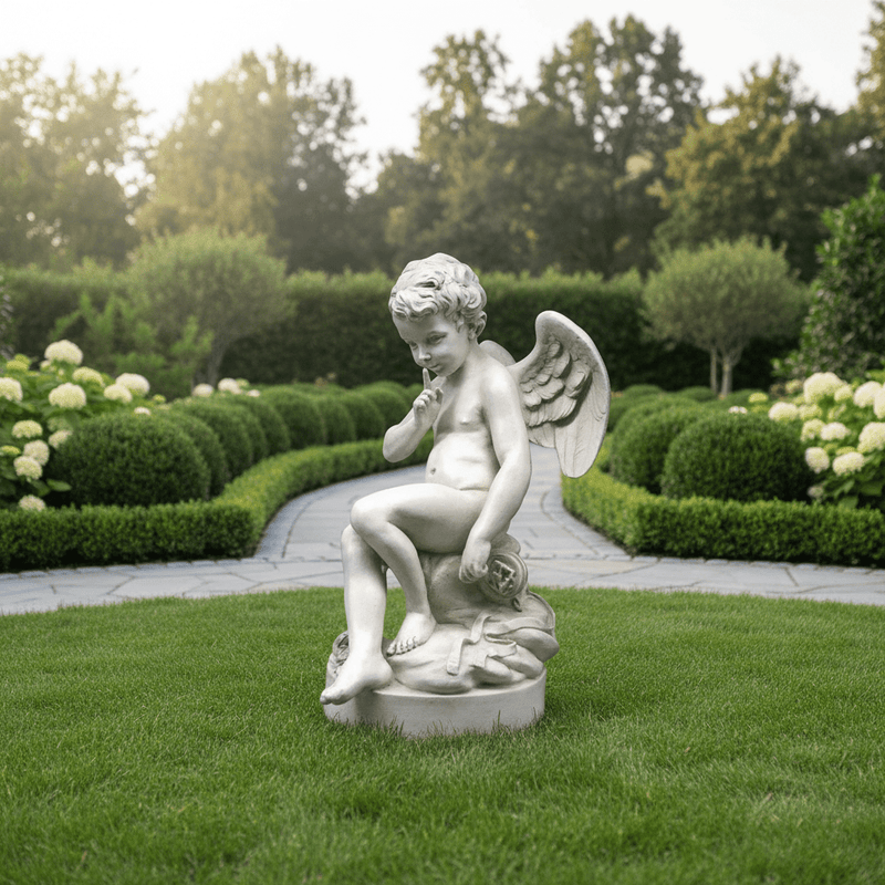 Sitting winged cherub with a finger to its lips in a "shushing" pose on a cloud-like base. Outdoor Statue (37-Inch)